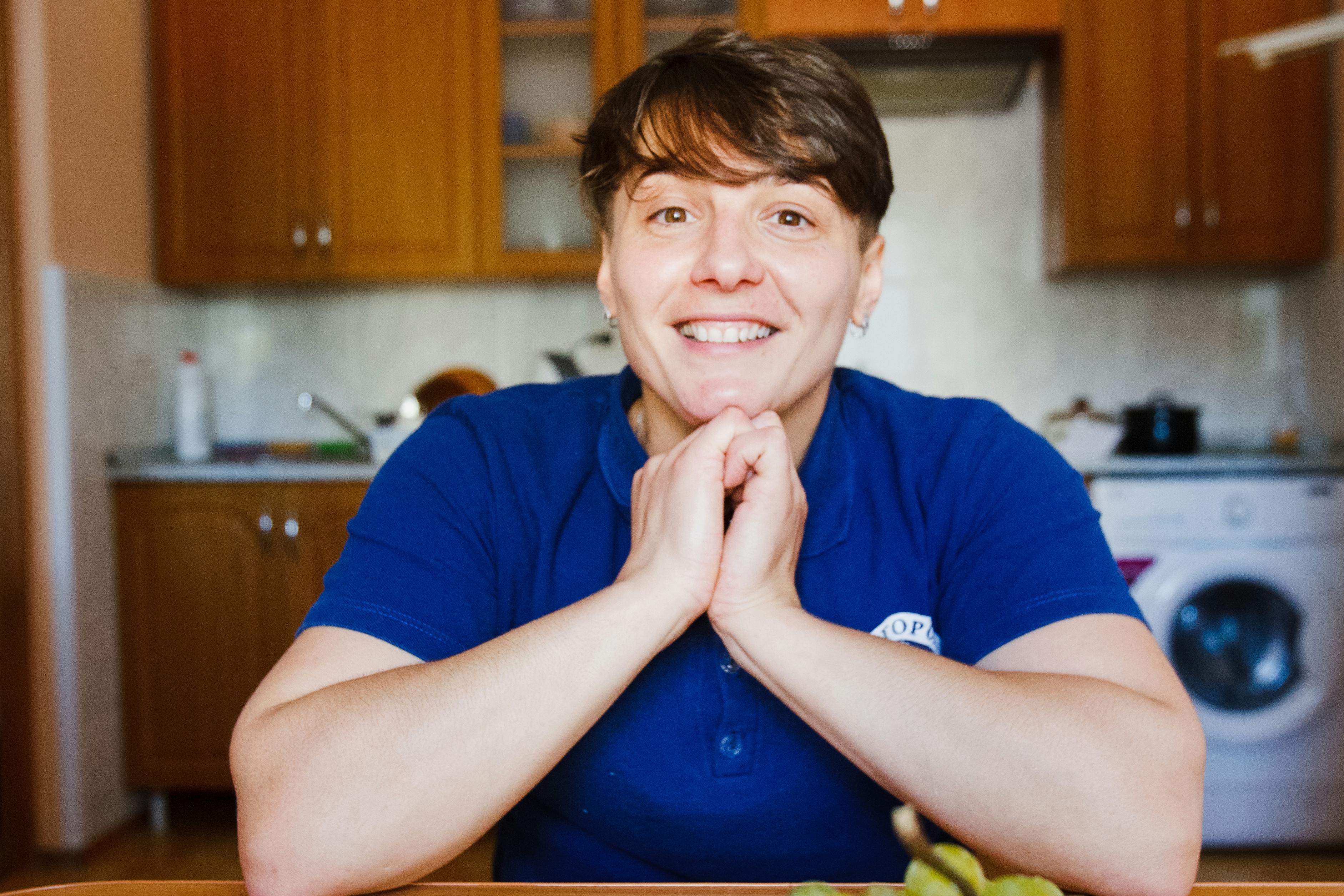 Claire, the friendly owner of Bright Nest Cleaning Co., smiling in a bright kitchen